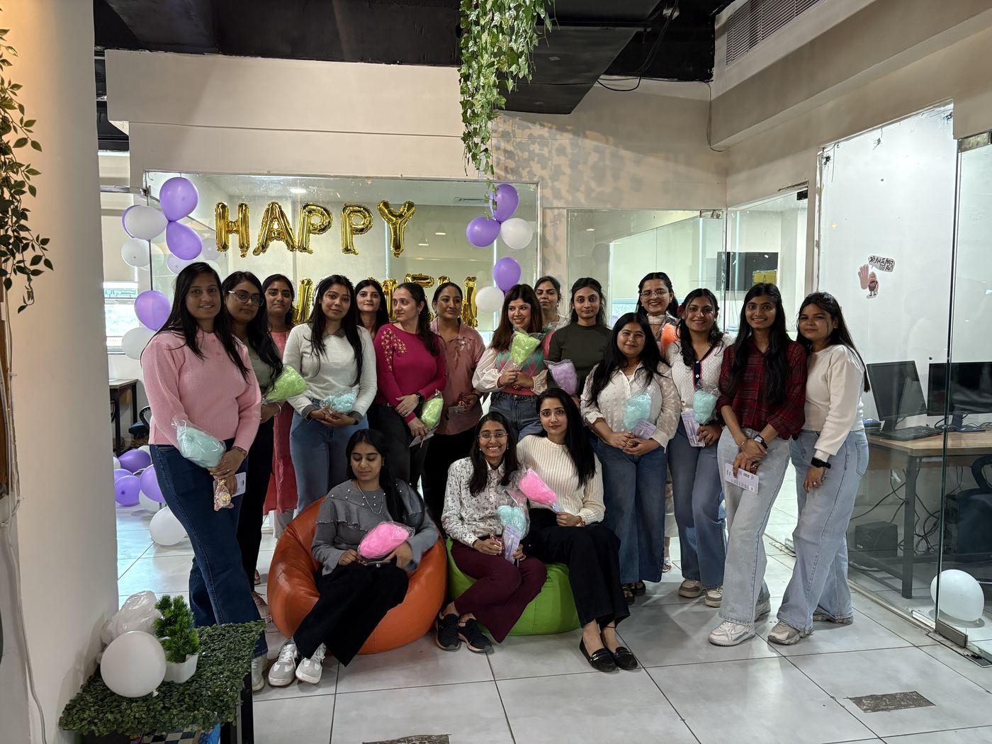 Balloons, gifts and the team celebrating together at the office