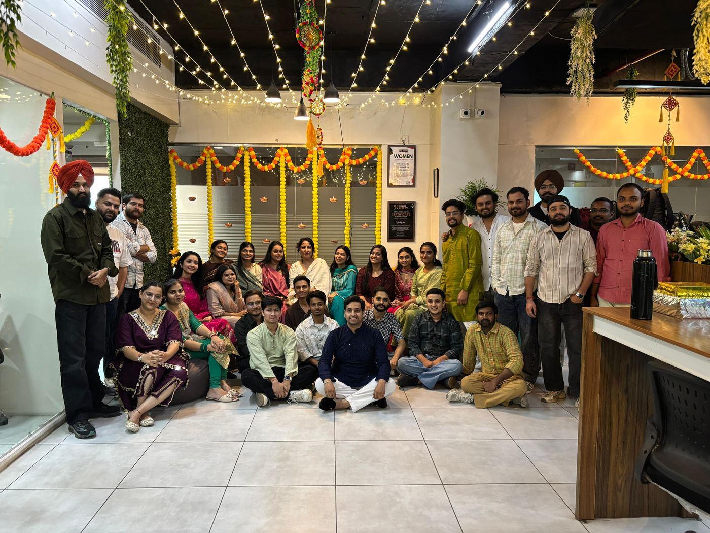 The team together under marigolds and fairy lights for Diwali at the Mohali office